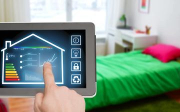 male hand adjusting smart home settings on tablet