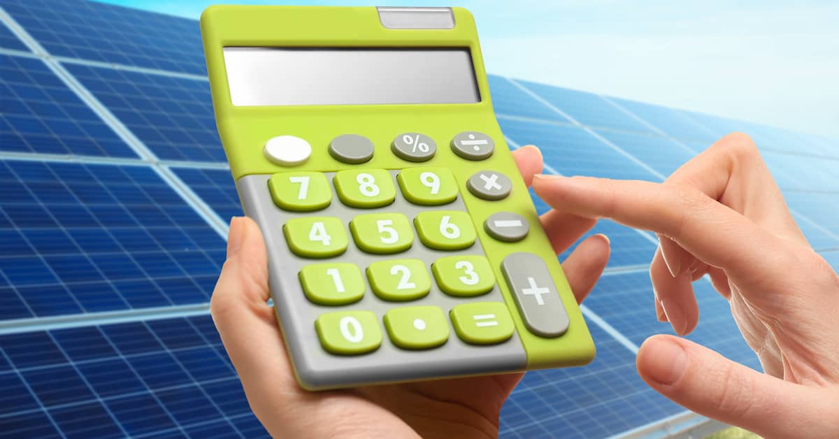 woman adding up the cost of solar panels on a calculator