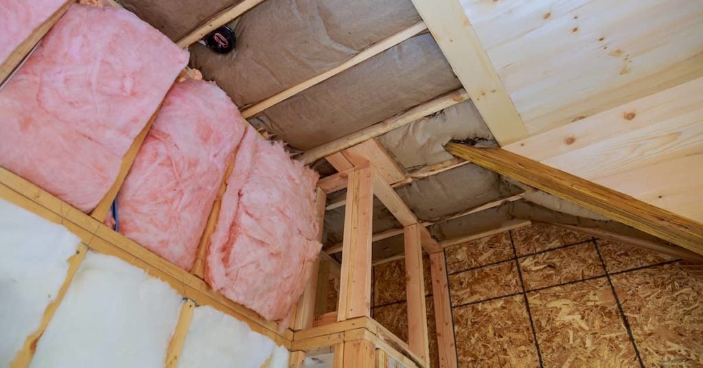 attic walls retrofitted with new fiberglass insulation